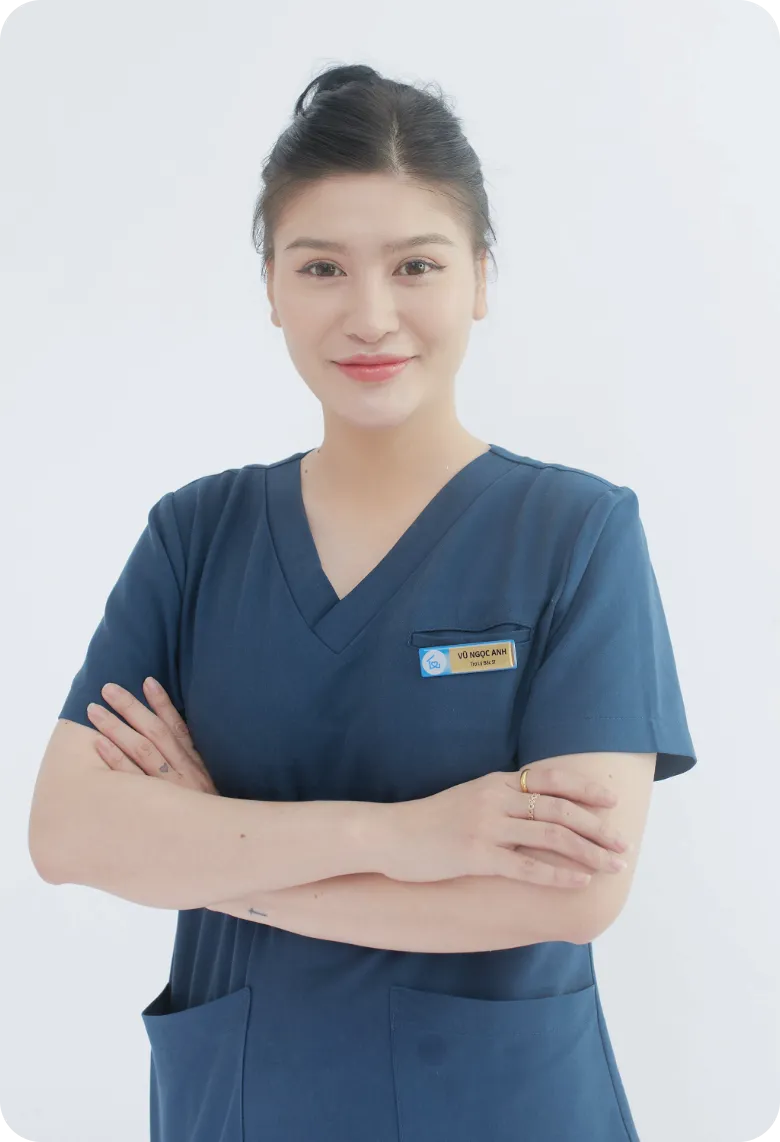 Professional Female Home Caregiver in Navy Blue Scrubs | Comfort Home Care Professional female home caregiver in navy blue scrubs standing with arms crossed